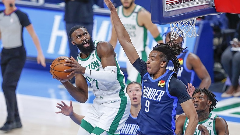 Mar 27, 2021; Oklahoma City, Oklahoma, USA; Boston Celtics guard Jaylen Brown (7) works to shoot as he is defended by Oklahoma City Thunder center Moses Brown (9) during the first quarter at Chesapeake Energy Arena. Mandatory Credit: Alonzo Adams-USA TODAY Sports