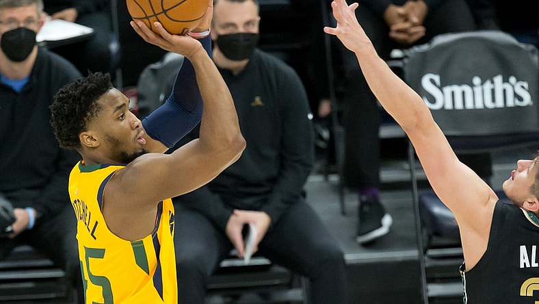 Mar 27, 2021; Salt Lake City, Utah, USA; Utah Jazz guard Donovan Mitchell (45) shoots the ball against Memphis Grizzlies guard Grayson Allen (3) during the first quarter at Vivint Smart Home Arena. Mandatory Credit: Russell Isabella-USA TODAY Sports
