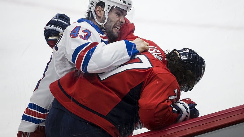 Mar 28, 2021; Washington, District of Columbia, USA; New York Rangers center Colin Blackwell (43) throws a puch at Washington Capitals right wing T.J. Oshie (77) during the first period at Capital One Arena. Mandatory Credit: Scott Taetsch-USA TODAY Sports