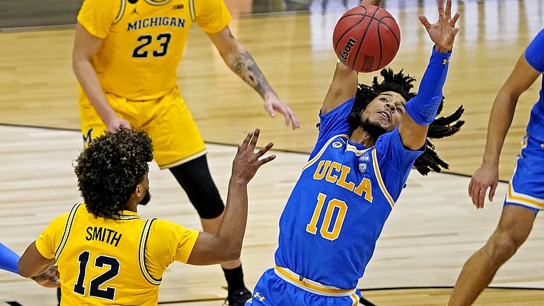 Mar 30, 2021; Indianapolis, IN, USA; UCLA Bruins guard Tyger Campbell (10) blocks a pass by Michigan Wolverines guard Mike Smith (12) during the second half in the Elite Eight of the 2021 NCAA Tournament at Lucas Oil Stadium. Mandatory Credit: Robert Deutsch-USA TODAY Sports