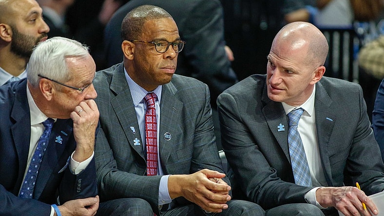 Feb 16, 2019; Winston-Salem, NC, USA; North Carolina Tar Heels head coach Roy Williams, left, talks to assistant coaches Hubert Davis, center, and Brad Frederick as the North Carolina Tar Heels play the Wake Forest Demon Deacons in the second half at Lawrence Joel Coliseum. The North Carolina Tar Heels won 95-57. Mandatory Credit: Nell Redmond-USA TODAY Sports