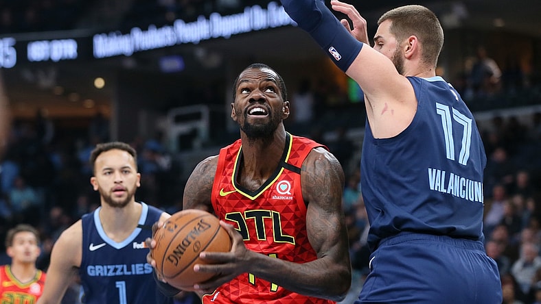 Mar 7, 2020; Memphis, Tennessee, USA; Atlanta Hawks center Dewayne Dedmon (14) drives against Memphis Grizzlies center Jonas Valanciunas (17) as Memphis forward Kyle Anderson (1) looks on at FedExForum. Mandatory Credit: Nelson Chenault-USA TODAY Sports