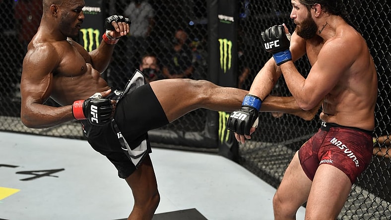 July 12, 2020; Abu Dhabi, UAE;  Kamaru Usman of Nigeria kicks Jorge Masvidal in their UFC welterweight championship fight during the UFC 251 event at Flash Forum on UFC Fight Island on July 12, 2020 on Yas Island, Abu Dhabi, United Arab Emirates.  Mandatory Credit: Jeff Bottari/Zuffa LLC via USA TODAY Sports