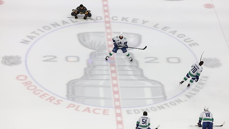 Aug 23, 2020; Edmonton, Alberta, CAN; Vancouver Canucks and Vegas Golden Knights players warm up at the center logo before game one of the second round of the 2020 Stanley Cup Playoffs at Rogers Place. Mandatory Credit: Gerry Thomas-USA TODAY Sports
