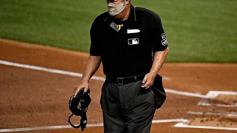 Sep 11, 2020; Miami, Florida, USA;  Home Plate umpire Joe West (22) walks on the field between innings of the game between the Miami Marlins and the Philadelphia Phillies at Marlins Park. Mandatory Credit: Jasen Vinlove-USA TODAY Sports