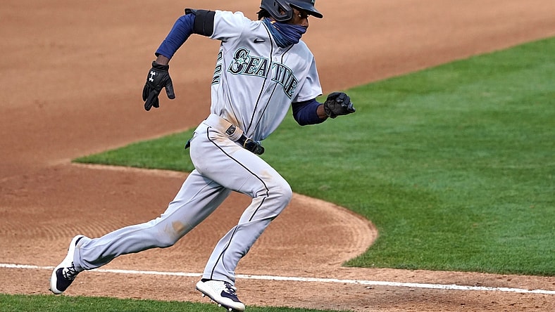 Sep 26, 2020; Oakland, California, USA; Seattle Mariners second baseman Dee Strange-Gordon (9) runs home to score a run against the Oakland Athletics during the fifth inning at Oakland Coliseum. Mandatory Credit: Darren Yamashita-USA TODAY Sports