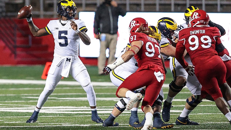Nov 21, 2020; Piscataway, New Jersey, USA; Michigan Wolverines quarterback Joe Milton (5) throws the ball against Rutgers Scarlet Knights defensive lineman Mike Tverdov (97) and defensive lineman Michael Dwumfour (99) during the first half at SHI Stadium. Mandatory Credit: Vincent Carchietta-USA TODAY Sports