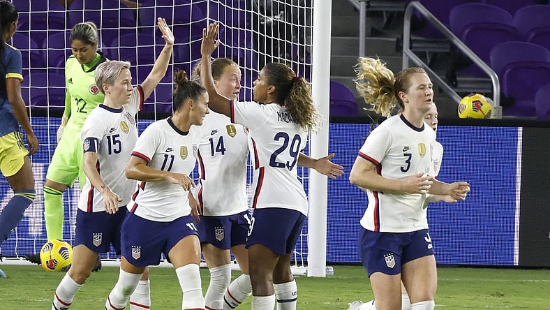 Jan 22, 2021; Orlando, Florida, USA;  the United States forward Megan Rapinoe (15) celebrates her goal with defender Sali Krieger (11) and Emily Sonnett (14) and midfielder Catarina Macario (29) as midfielder Sam Mewis (3) heads back to mid field during the first half against Colombia at Exploria Stadium. Mandatory Credit: Reinhold Matay-USA TODAY Sports