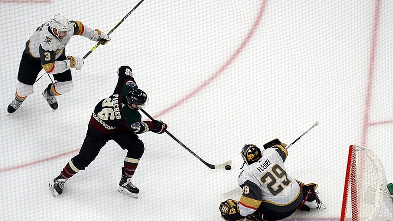 Jan 24, 2021; Glendale, Arizona, USA; Vegas Golden Knights goaltender Marc-Andre Fleury (29) makes a save against Arizona Coyotes right wing Christian Fischer (36) during the third period at Gila River Arena. Mandatory Credit: Joe Camporeale-USA TODAY Sports