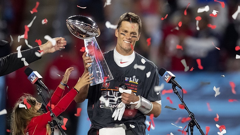 Feb 7, 2021; Tampa, FL, USA;  Confetti falls as Tampa Bay Buccaneers quarterback Tom Brady (12) celebrates with the Vince Lombardi Trophy after beating the Kansas City Chiefs in Super Bowl LV at Raymond James Stadium.  Mandatory Credit: Mark J. Rebilas-USA TODAY Sports
