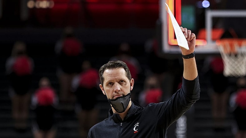 Feb 14, 2021; Cincinnati, Ohio, USA; Cincinnati Bearcats head coach John Brannen reacts to fans after defeating the UCF Knights at Fifth Third Arena. Mandatory Credit: Aaron Doster-USA TODAY Sports