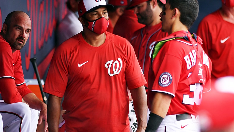 Mar 3, 2021; West Palm Beach, Florida, USA; Washington Nationals manager Dave Martinez (left) talks with catcher Tres Barrera (38) during a spring training game against the Miami Marlins at Ballpark of the Palm Beaches. Mandatory Credit: Jim Rassol-USA TODAY Sports