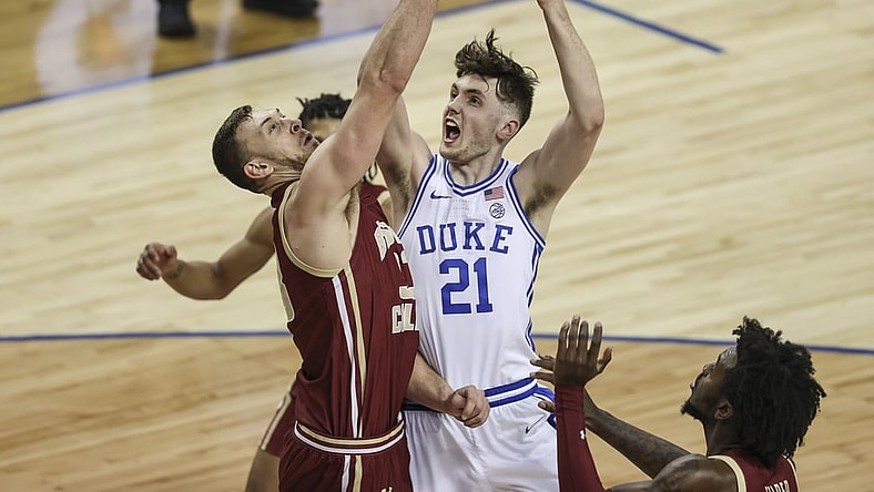 Mar 9, 2021; Greensboro, North Carolina, USA; Duke Blue Devils forward Matthew Hurt (21) drives to the basket against Boston College Eagles forward James Karnik (33) during the second half in the first round of the 2021 ACC men's basketball tournament at Greensboro Coliseum. Mandatory Credit: Nell Redmond-USA TODAY Sports