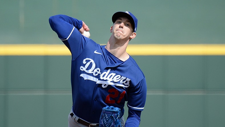Mar 12, 2021; Goodyear, Arizona, USA; Los Angeles Dodgers starting pitcher Walker Buehler (21) pitches against the Cleveland Indians during the first inning of a spring training game at Goodyear Ballpark. Mandatory Credit: Joe Camporeale-USA TODAY Sports