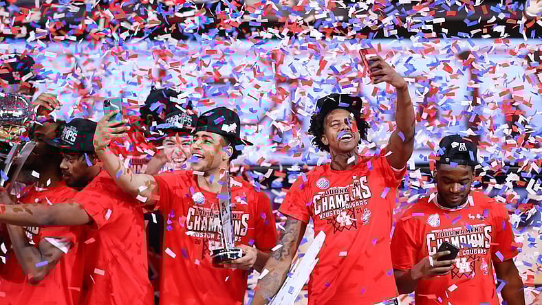 Mar 14, 2021; Fort Worth, TX, USA; Houston Cougars players celebrate as confetti falls after defeating the Cincinnati Bearcats in the American Athletic Conference tournament final at Dickies Arena. Mandatory Credit: Ben Ludeman-USA TODAY Sports
