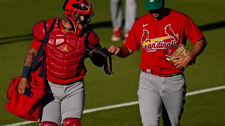 Mar 17, 2021; West Palm Beach, Florida, USA; St. Louis Cardinals catcher Yadier Molina (4) fist bumps starting pitcher Adam Wainwright (50) prior to the spring training game against the Houston Astros at The Ballpark of the Palm Beaches. Mandatory Credit: Jasen Vinlove-USA TODAY Sports