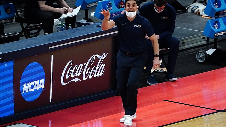 Mar 20, 2021; Indianapolis, Indiana, USA; UNCG Spartans head coach Wes Miller (C) gestures during the first half against the Florida State Seminoles in the first round of the 2021 NCAA Tournament at Bankers Life Fieldhouse. Mandatory Credit: Kirby Lee-USA TODAY Sports