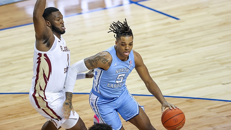 Mar 12, 2021; Greensboro, North Carolina, USA; North Carolina Tar Heels forward Armando Bacot (5) drives to the basket against Florida State Seminoles forward RaiQuan Gray (1) in the first half in the 2021 ACC tournament semifinal game at Greensboro Coliseum. The Florida State Seminoles won 69-66. Mandatory Credit: Nell Redmond-USA TODAY Sports