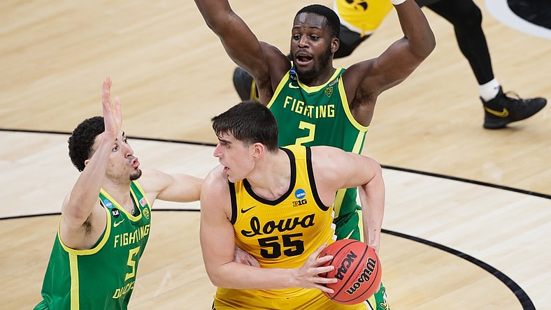 Iowa Hawkeyes center Luka Garza (55) attempts to evade Oregon Ducks guard Chris Duarte (5) and forward Eugene Omoruyi (2) during the second round of the 2021 NCAA Tournament on Monday, March 22, 2021, at Bankers Life Fieldhouse in Indianapolis, Ind. Mandatory Credit: Barbara Perenic/IndyStar via USA TODAY Sports