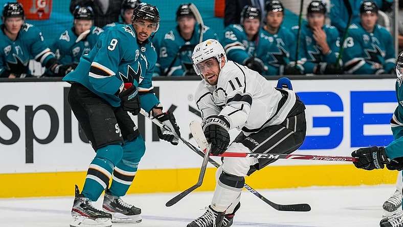 Mar 24, 2021; San Jose, California, USA;  Los Angeles Kings center Anze Kopitar (11) reaches for the puck during the first period against the San Jose Sharks at SAP Center at San Jose. Mandatory Credit: Stan Szeto-USA TODAY Sports