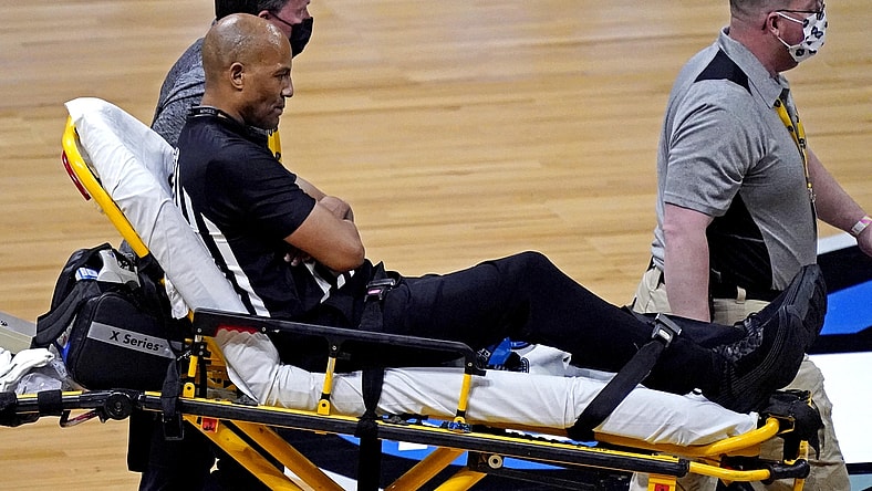 Mar 30, 2021; Indianapolis, IN, USA; A NCAA referee is helped off the court after falling on the court during the game between the Gonzaga Bulldogs and the USC Trojans in the Elite Eight of the 2021 NCAA Tournament at Lucas Oil Stadium. Mandatory Credit: Robert Deutsch-USA TODAY Sports
