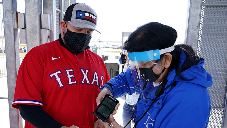 Apr 1, 2021; Kansas City, Missouri, USA; A Texas Rangers fan is scanned into the park via contactless scanners before the Opening Day game against the Texas Rangers at Kauffman Stadium. Mandatory Credit: Denny Medley-USA TODAY Sports