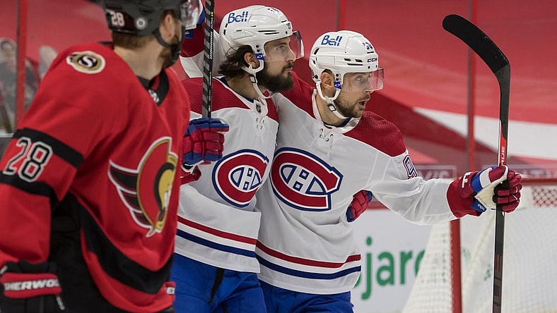 Apr 1, 2021; Ottawa, Ontario, CAN; Montreal Canadiens center Phillip Danault (24) celebrates with left wing Thomas Tatar (90) as Ottawa Senators right wing Connor Brown (28) skates past in the first period at the Canadian Tire Centre. Mandatory Credit: Marc DesRosiers-USA TODAY Sports
