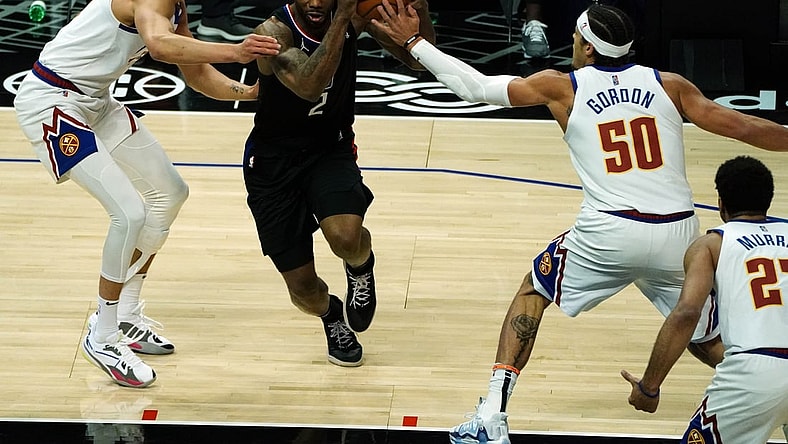 Apr 1, 2021; Los Angeles, California, USA; Los Angeles Clippers forward Kawhi Leonard (2) moves the ball against Denver Nuggets forward Will Barton (5) and forward Aaron Gordon (50) during the first half at Staples Center. Mandatory Credit: Gary A. Vasquez-USA TODAY Sports