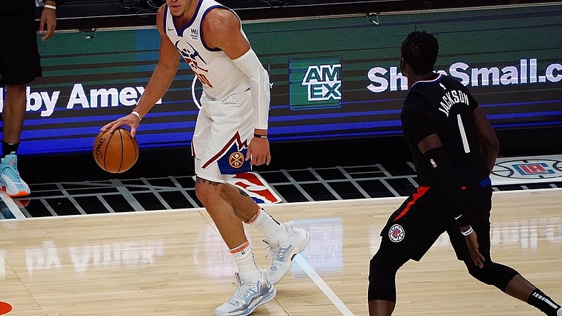 Apr 1, 2021; Los Angeles, California, USA; Denver Nuggets forward Aaron Gordon (50) controls the ball against Los Angeles Clippers guard Reggie Jackson (1) during the first half at Staples Center. Mandatory Credit: Gary A. Vasquez-USA TODAY Sports