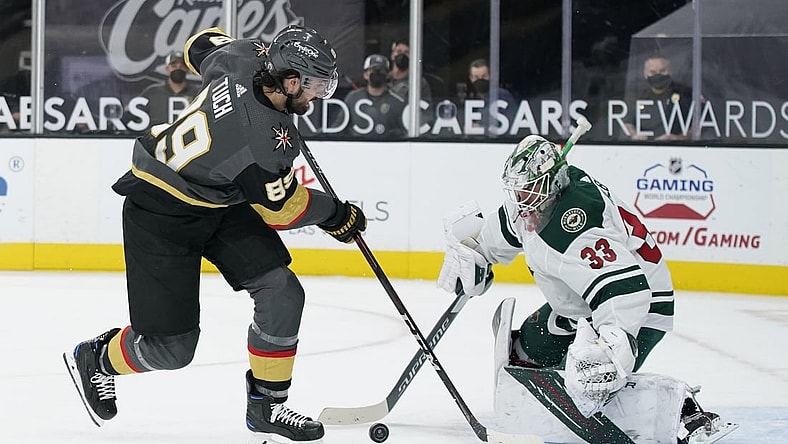 Apr 1, 2021; Las Vegas, Nevada, USA; Minnesota Wild goaltender Cam Talbot (33) blocks a shot by Vegas Golden Knights right wing Alex Tuch (89) during the second period at T-Mobile Arena. Mandatory Credit: John Locher/The Associated Press via USA TODAY Network )
