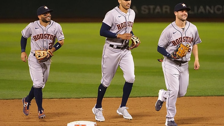 Apr 1, 2021; Oakland, California, USA; Houston Astros second baseman Jose Altuve (27), shortstop Carlos Correa (1) and left fielder Chas McCormick (6) celebrate after a win against the Oakland Athletics at RingCentral Coliseum. Mandatory Credit: Kelley L Cox-USA TODAY Sports