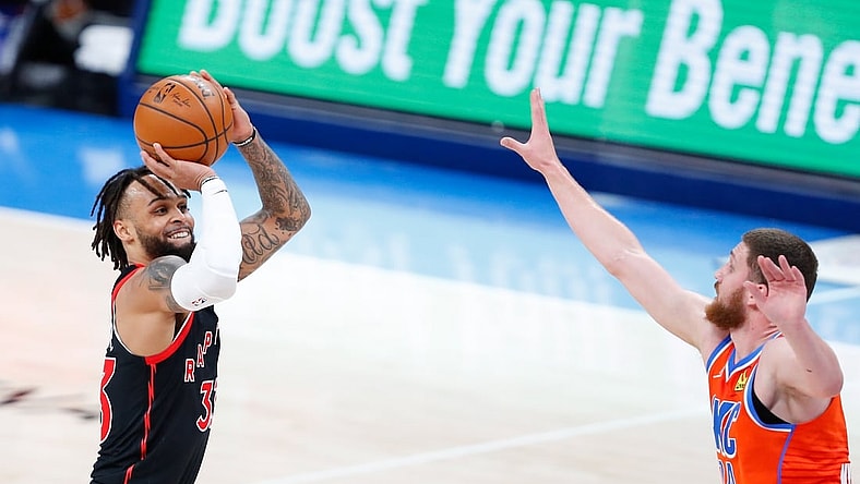 Mar 31, 2021; Oklahoma City, Oklahoma, USA; Toronto Raptors guard Gary Trent Jr. (33) shoots a three point basket as Oklahoma City Thunder guard Svi Mykhailiuk (14) defends the shot during the second half at Chesapeake Energy Arena. Mandatory Credit: Alonzo Adams-USA TODAY Sports