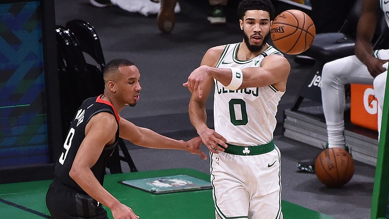Apr 2, 2021; Boston, Massachusetts, USA;  Boston Celtics forward Jayson Tatum (0) passes the ball past Houston Rockets guard Avery Bradley (9) during the first half at TD Garden. Mandatory Credit: Bob DeChiara-USA TODAY Sports