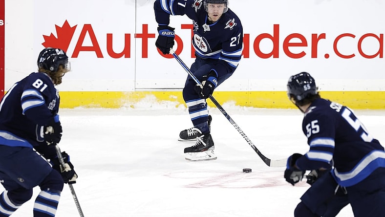 Apr 2, 2021; Winnipeg, Manitoba, CAN;  Winnipeg Jets left wing Nikolaj Ehlers (27) skates up the ice with teammates Winnipeg Jets left wing Kyle Connor (81) and Winnipeg Jets center Mark Scheifele (55) in the first period against the Toronto Maple Leafs at Bell MTS Place. Mandatory Credit: James Carey Lauder-USA TODAY Sports