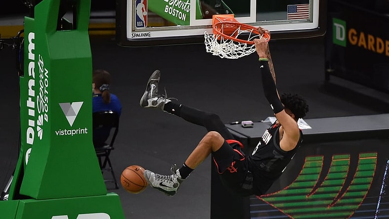Apr 2, 2021; Boston, Massachusetts, USA;  Houston Rockets center Christian Wood (35) hangs onto the rim after dunking the ball during the second half against the Boston Celtics at TD Garden. Mandatory Credit: Bob DeChiara-USA TODAY Sports