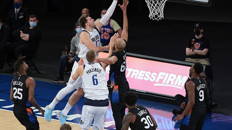 Apr 2, 2021; New York, New York, USA; Dallas Mavericks guard Luka Doncic (77) drives to the basket against New York Knicks center Taj Gibson (67) during the second half at Madison Square Garden. Mandatory Credit: Vincent Carchietta-USA TODAY Sports