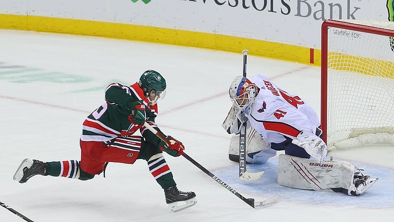 Apr 2, 2021; Newark, New Jersey, USA; Washington Capitals goaltender Vitek Vanecek (41) makes a save on New Jersey Devils center Jack Hughes (86) during overtime at Prudential Center. Mandatory Credit: Ed Mulholland-USA TODAY Sports