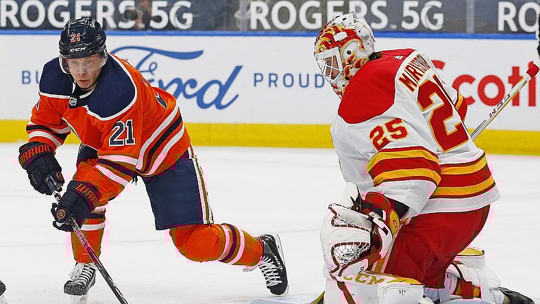 Apr 2, 2021; Edmonton, Alberta, CAN; Edmonton Oilers forward Dominik Kahun (21) tries to take shot against Calgary Flames goaltender Jacob Markstrom (25) during the first period at Rogers Place. Mandatory Credit: Perry Nelson-USA TODAY Sports