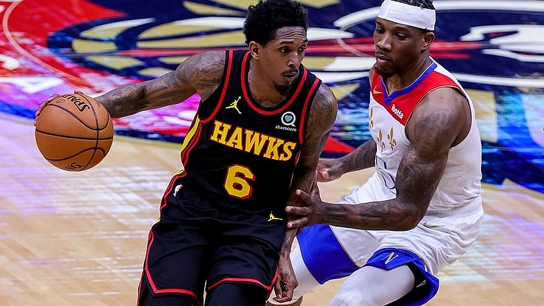 Apr 2, 2021; New Orleans, Louisiana, USA;  Atlanta Hawks guard Lou Williams (6) dribbles around New Orleans Pelicans guard Eric Bledsoe (5) during the first half at the Smoothie King Center. Mandatory Credit: Stephen Lew-USA TODAY Sports