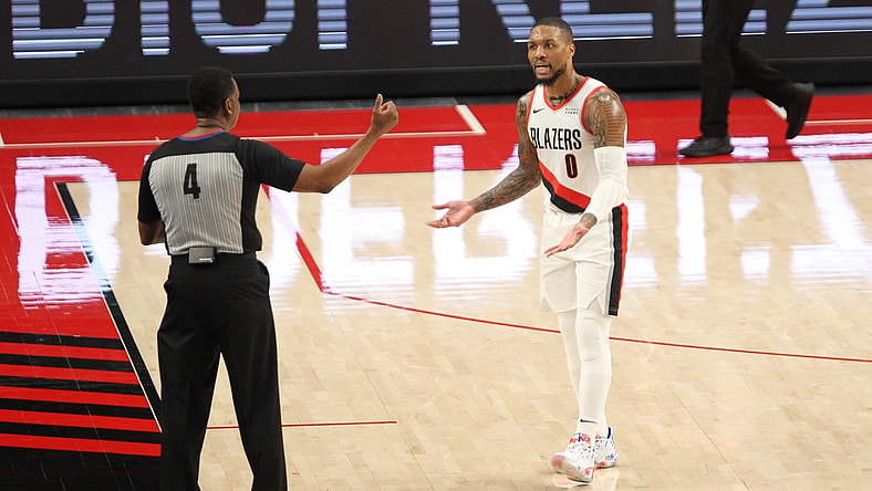 Apr 2, 2021; Portland, Oregon, USA; Portland Trail Blazers guard Damian Lillard (0) pleads his case to referee Sean Wright (4) after being called for a foul in the first half at Moda Center. Mandatory Credit: Jaime Valdez-USA TODAY Sports