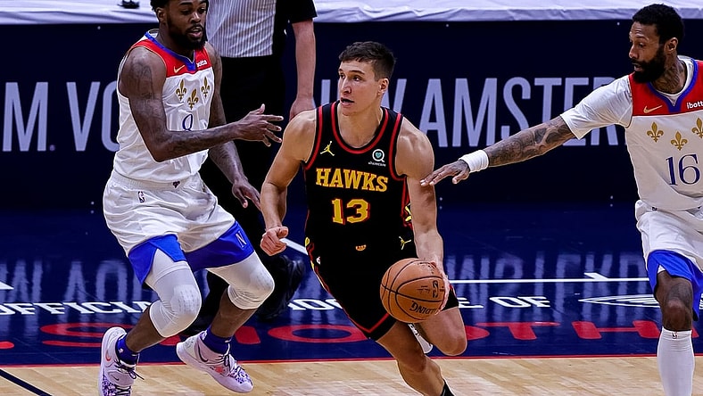 Apr 2, 2021; New Orleans, Louisiana, USA;  Atlanta Hawks guard Bogdan Bogdanovic (13) dribbles against New Orleans Pelicans forward James Johnson (16) during the second half at the Smoothie King Center. Mandatory Credit: Stephen Lew-USA TODAY Sports