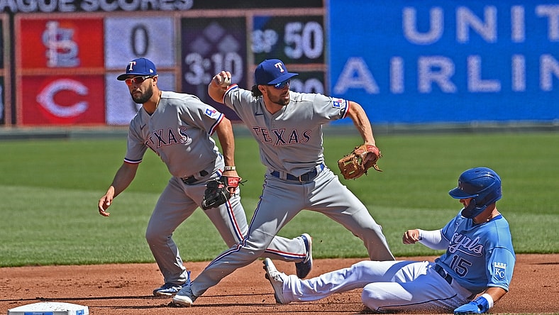 Apr 3, 2021; Kansas City, Missouri, USA; Texas Rangers third basemen Charlie Culberson (2) doubles up Kansas City Royals right fielder Whit Merrifield (15) at second base during the first inning at Kauffman Stadium. Mandatory Credit: Peter Aiken-USA TODAY Sports