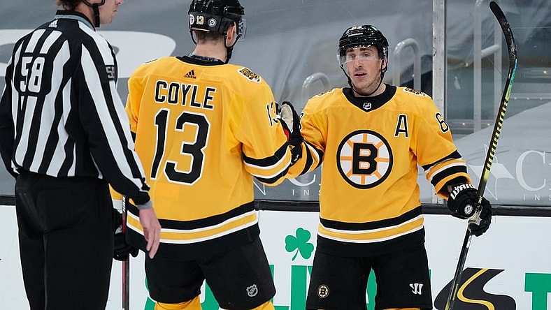 Apr 3, 2021; Boston, Massachusetts, USA; Boston Bruins center Brad Marchand (63) is congratulated by center Charlie Coyle (13) after scoring his third goal of the game against the Pittsburgh Penguins in the third period at TD Garden. Mandatory Credit: David Butler II-USA TODAY Sports