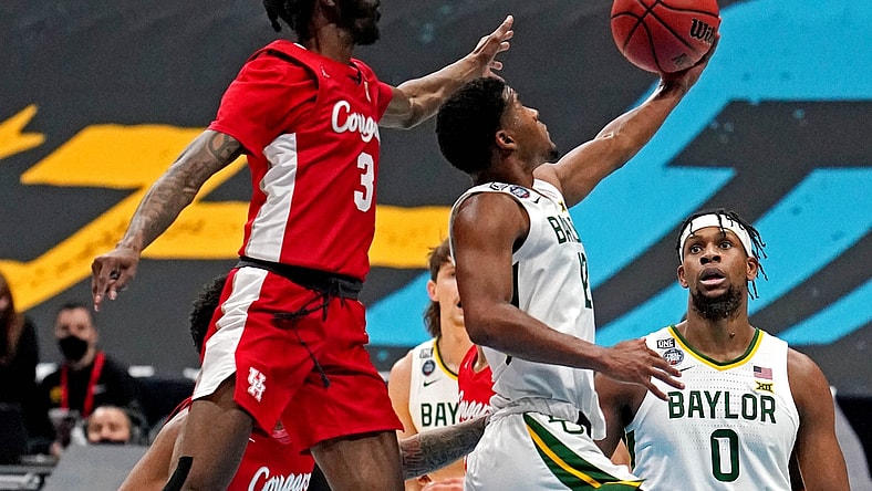 Apr 3, 2021; Indianapolis, Indiana, USA; Baylor Bears guard Jared Butler (12) shoots the ball against Houston Cougars guard DeJon Jarreau (3) during the first half in the national semifinals of the Final Four of the 2021 NCAA Tournament at Lucas Oil Stadium. Mandatory Credit: Kyle Terada-USA TODAY Sports