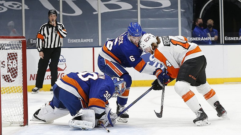 Apr 3, 2021; Uniondale, New York, USA; New York Islanders goaltender Ilya Sorokin (30) covers the puck as defenseman Ryan Pulock (6) checks Philadelphia Flyers center Sean Couturier (14) during the first period at Nassau Veterans Memorial Coliseum. Mandatory Credit: Andy Marlin-USA TODAY Sports
