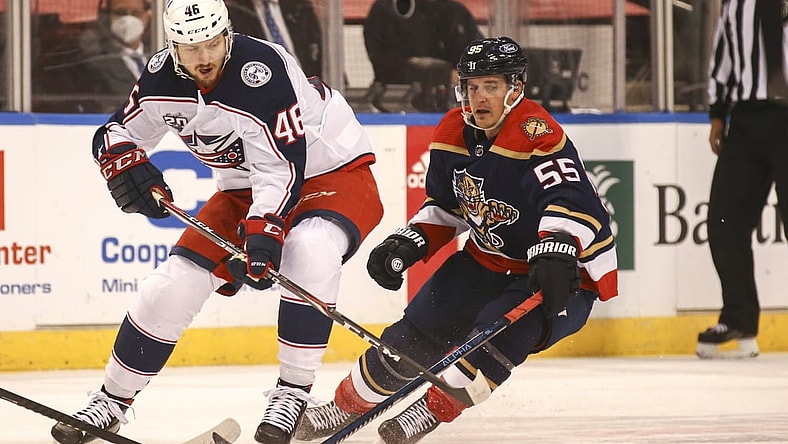 Apr 3, 2021; Sunrise, Florida, USA; Columbus Blue Jackets defenseman Dean Kukan (46) skates with the puck around Florida Panthers center Noel Acciari (55) during the first period at BB&T Center. Mandatory Credit: Sam Navarro-USA TODAY Sports