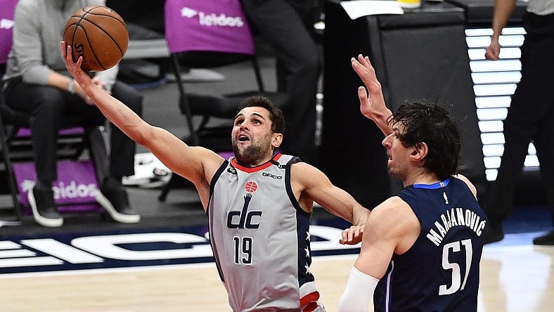 Apr 3, 2021; Washington, District of Columbia, USA; Washington Wizards guard Raul Neto (19) shoots past Dallas Mavericks center Boban Marjanovic (51) during the second quarter at Capital One Arena. Mandatory Credit: Brad Mills-USA TODAY Sports