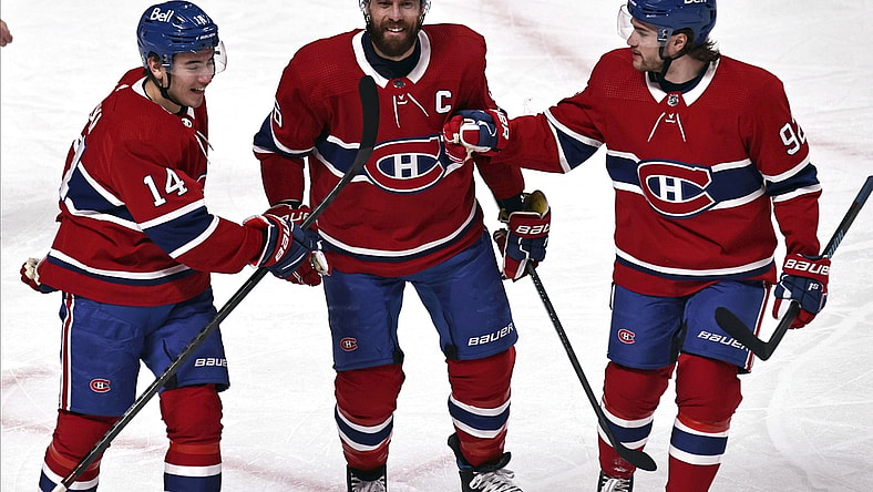 Apr 3, 2021; Montreal, Quebec, CAN; Montreal Canadiens center Nick Suzuki (14) and defenseman Shea Weber (6) and left wing Jonathan Drouin (92) celebrate after goal by right wing Tyler Toffoli (not pictured) against the Ottawa Senators during the first period at Bell Centre. Mandatory Credit: Jean-Yves Ahern-USA TODAY Sports