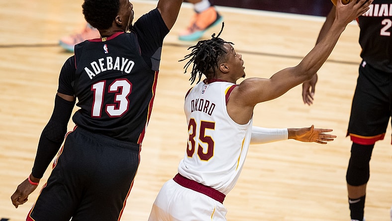 Apr 3, 2021; Miami, Florida, USA; Cleveland Cavaliers forward Isaac Okoro (35) attempts a layup past Miami Heat center Bam Adebayo (13) during the second quarter of a game at American Airlines Arena. Mandatory Credit: Mary Holt-USA TODAY Sports