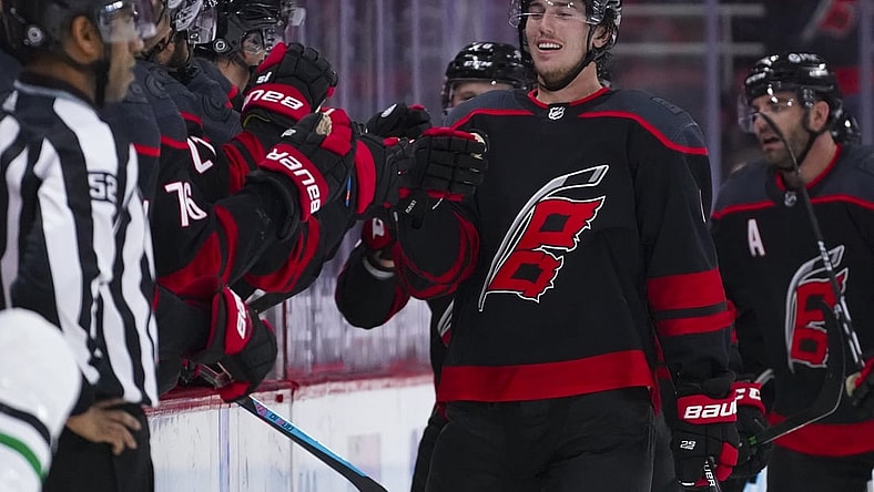 Apr 3, 2021; Raleigh, North Carolina, USA;  Carolina Hurricanes defenseman Haydn Fleury (4) celebrates after scoring a second period goal against the Dallas Stars at PNC Arena. Mandatory Credit: James Guillory-USA TODAY Sports